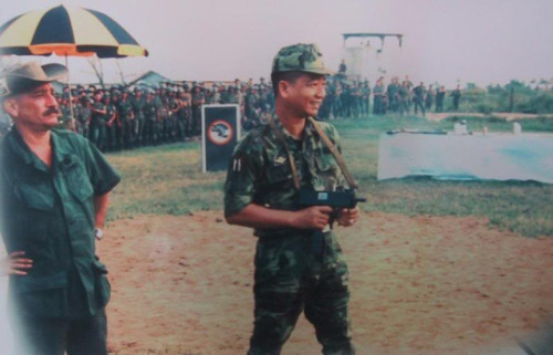 An ARVN officer tests an unsuppressed MAC-10 as WerBell looks on