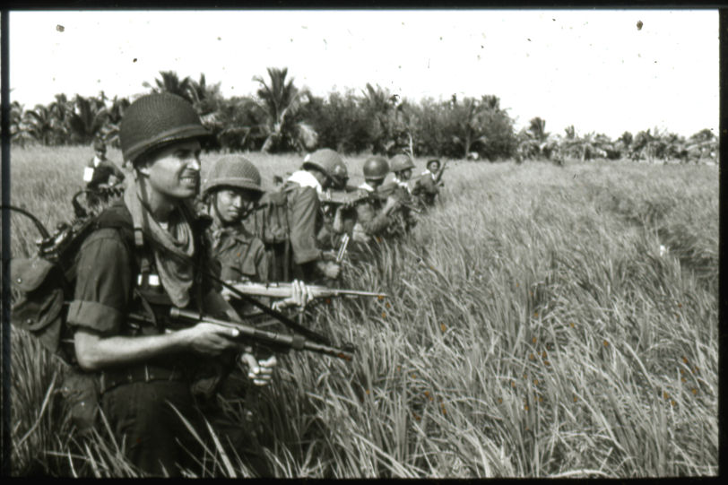 Capt. Richard A. Jones with Vietnamese Eagle Force troops he advises. Photo by Richard Tregaskis.