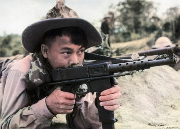 A soldier of the National Liberation Front (N.L.F), armed with a French MAT-49 sub-machine gun.