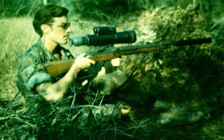 A 25th Infantry Division sniper is seen here in Vietnam wielding an XM21 sniper rifle outfitted with an AN/PVS-2 Starlight scope and Sionics sound suppressor. This was state of the art at the time.