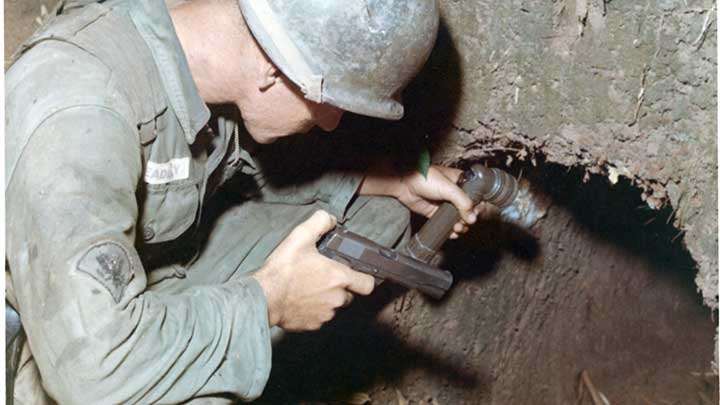 The entrance to Hell: A GI of the 25th Infantry checks the entrance to a VC tunnel outside Phu Hoa Dong during Operation Cedar Falls in January, 1967.