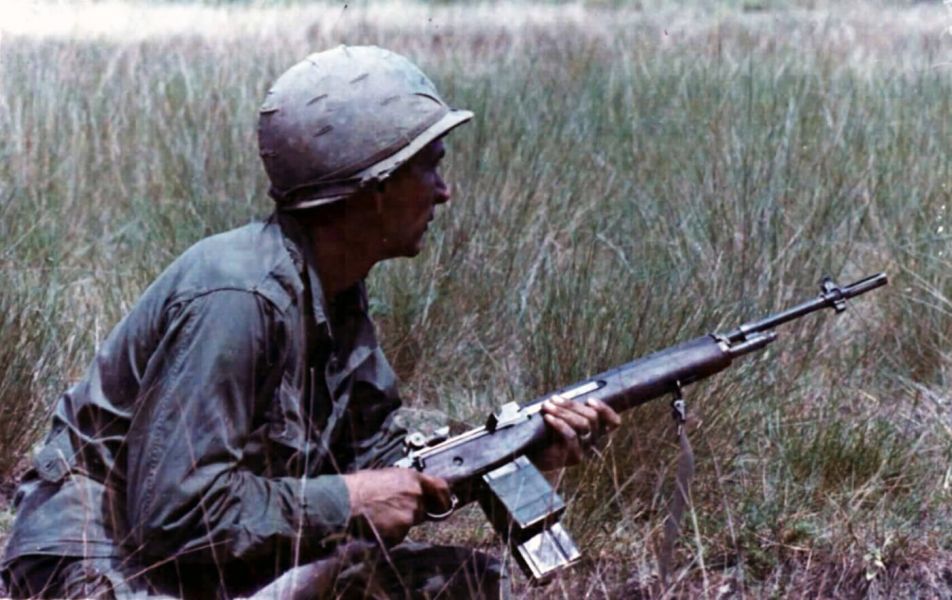 GI in the field with a jungle magazine