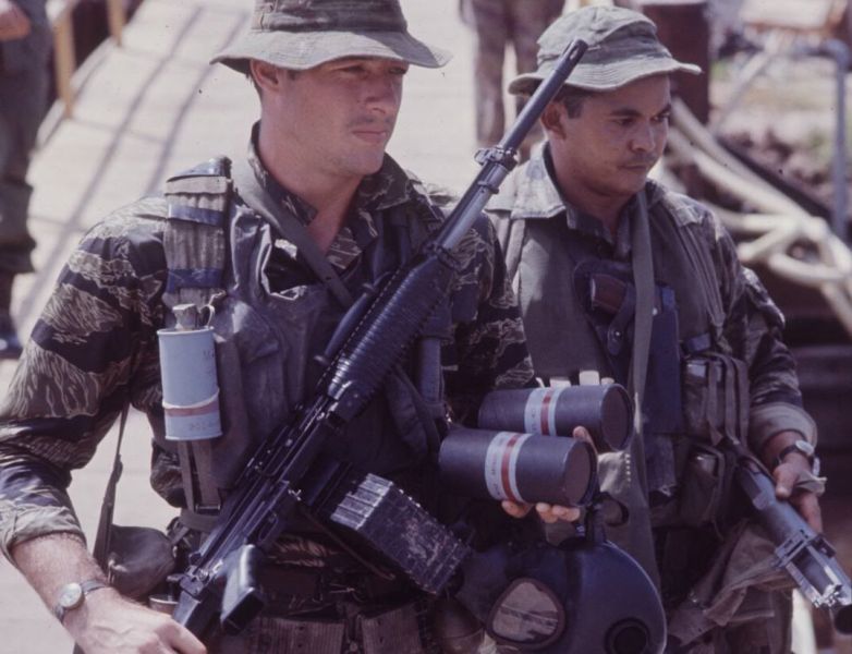 Soldier equipped with a Stoner 63A LMG and Smoke Grenades