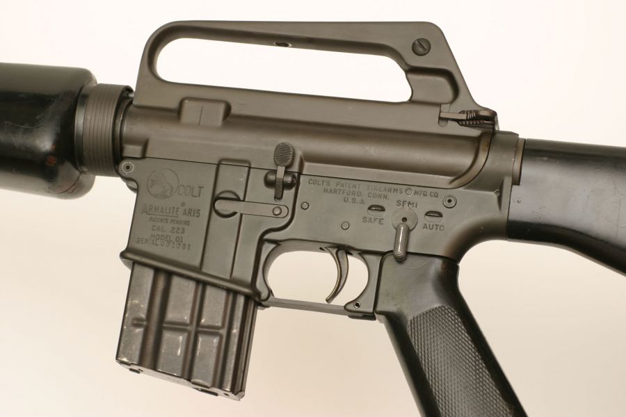 Left side closeup of Colt/ArmaLite Model 601 Serial No. 001081. The rifle’s original green painted furniture has been replaced by black painted furniture.