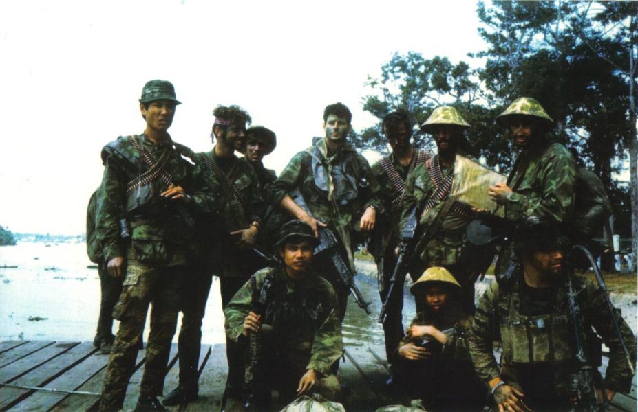 Navy SEALS X-Ray Platoon. Taken on a dock near Ben Tre in Southeast Vietnam. The SEAL in the center of the group, Lt. Michael Collins, is carrying a Stoner 63A1 Mk 23 Mod 0 Commando with a short 15.7 in (398.8 mm) barrel. Lt. Michael Collins, KIA March 4th, 1971. Photo credit: US Navy.
