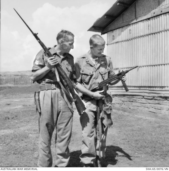 A U.S. Army soldier (right) holds a captured Vietcong M-50 in 1965